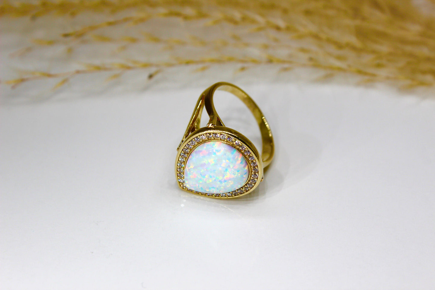 Opal drops in 14K yellow gold surrounded by zirconia stones in bezel setting
