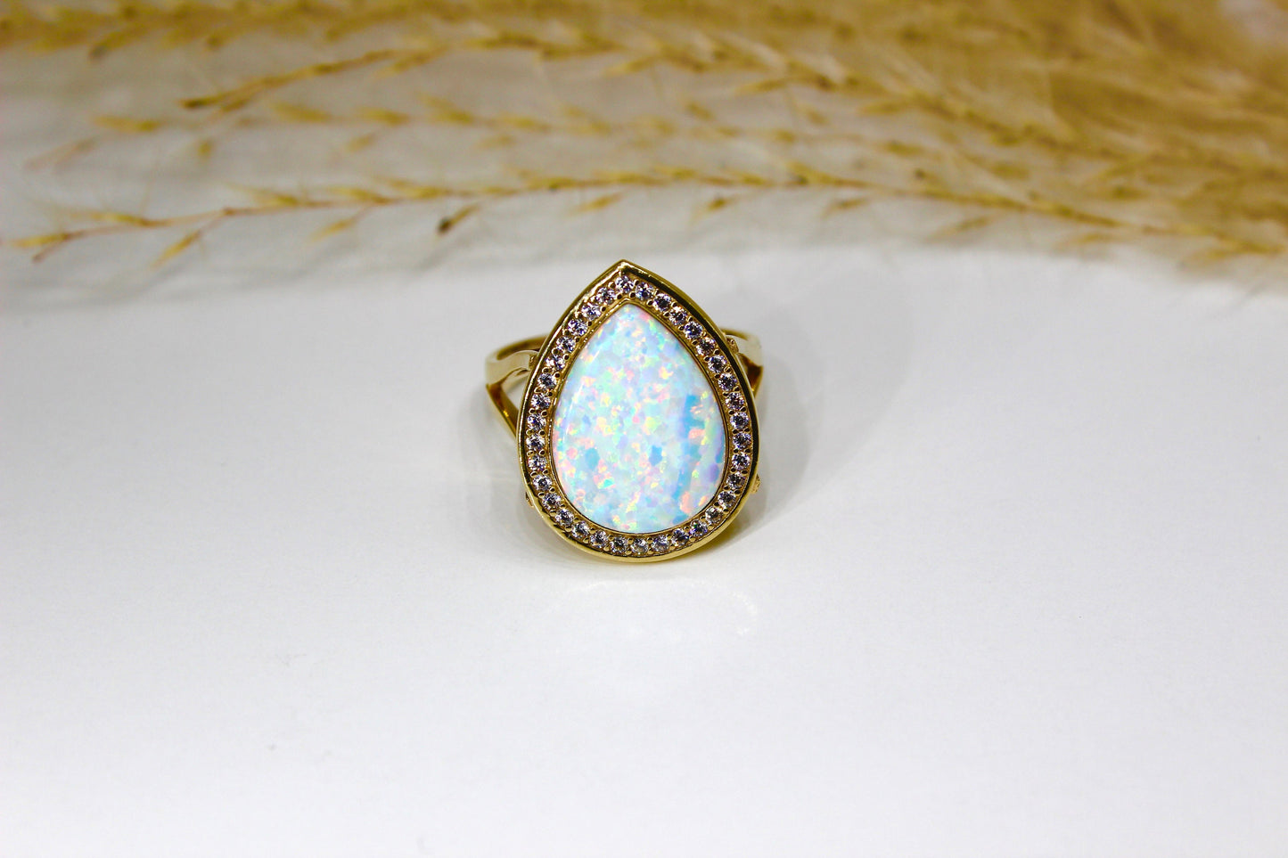 Opal drops in 14K yellow gold surrounded by zirconia stones in bezel setting