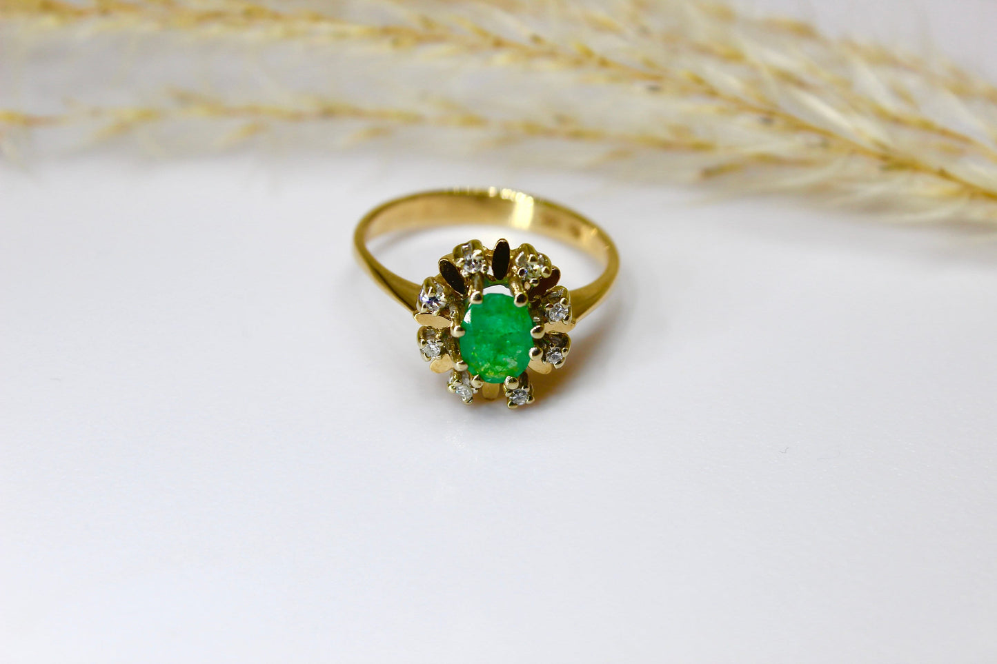 Vintage emerald ring in 14K yellow gold surrounded by octagon cut diamonds