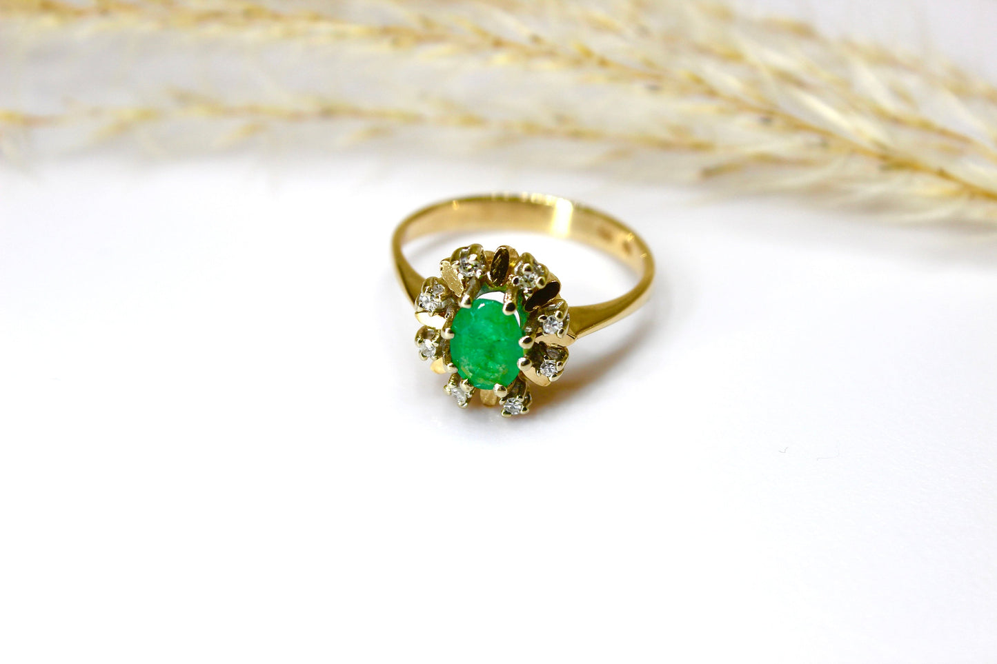 Vintage emerald ring in 14K yellow gold surrounded by octagon cut diamonds