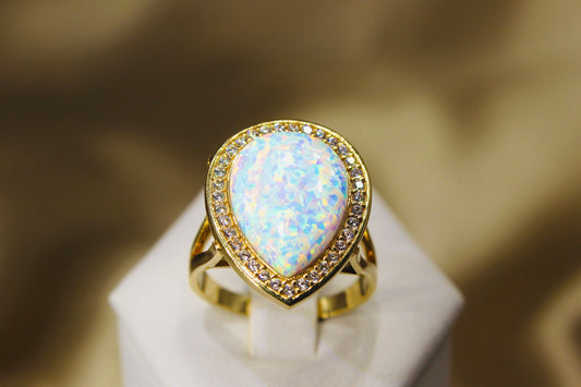 Opal drops in 14K yellow gold surrounded by zirconia stones in bezel setting