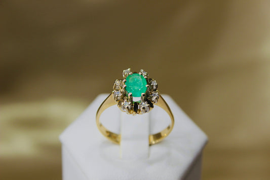 Vintage emerald ring in 14K yellow gold surrounded by octagon cut diamonds