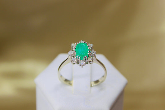Vintage emerald ring in 14K white gold surrounded by octagon cut diamonds